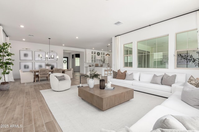 1248 E Jude Ln, Gilbert, AZ 85298 - living area with light wood finished floors, recessed lighting, and a chandelier