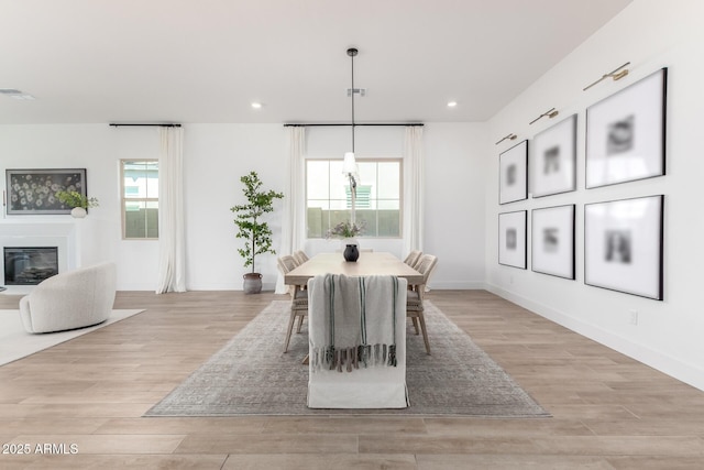 1248 E Jude Ln, Gilbert, AZ 85298 - dining area with light wood finished floors, recessed lighting, a glass covered fireplace, and baseboards