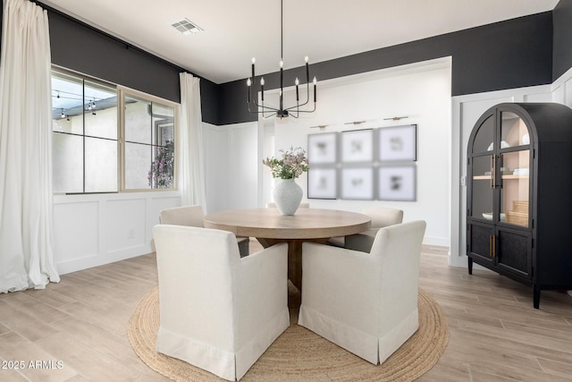 1248 E Jude Ln, Gilbert, AZ 85298 - dining room with a chandelier, light wood finished floors, and a decorative wall
