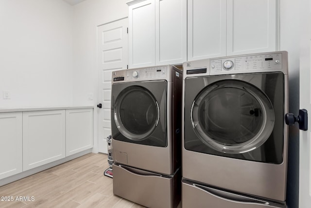 1248 E Jude Ln, Gilbert, AZ 85298 - laundry room with washing machine and clothes dryer, cabinet space, and light wood-type flooring
