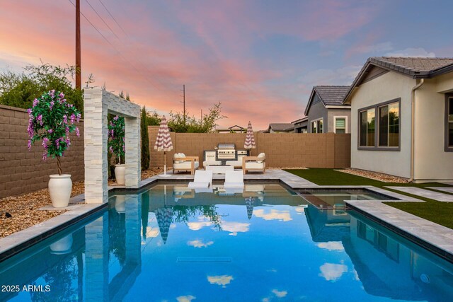 1248 E Jude Ln, Gilbert, AZ 85298 - pool at dusk featuring a fenced backyard and a patio