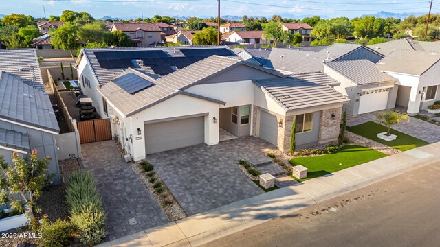 1248 E Jude Ln, Gilbert, AZ 85298 - view of front facade with a garage, stucco siding, solar panels, decorative driveway, and a residential view