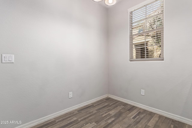 spare room with dark hardwood / wood-style flooring