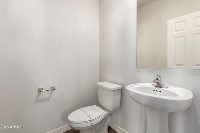 bathroom featuring toilet and sink