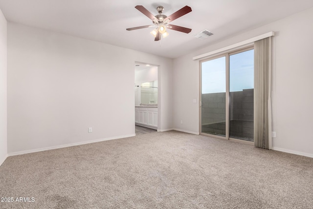 carpeted spare room with ceiling fan