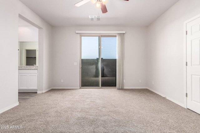 carpeted empty room featuring ceiling fan