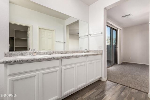 bathroom with vanity and hardwood / wood-style floors