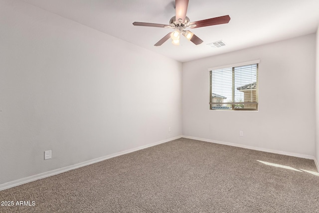 carpeted spare room with ceiling fan