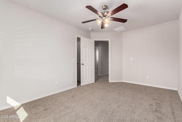 carpeted empty room featuring ceiling fan