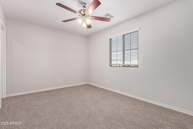 spare room featuring ceiling fan and carpet