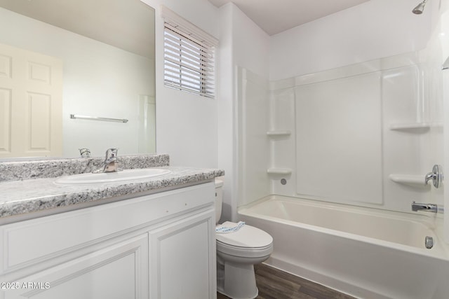 full bathroom featuring shower / washtub combination, hardwood / wood-style floors, vanity, and toilet