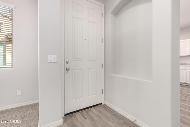 entryway with light hardwood / wood-style floors