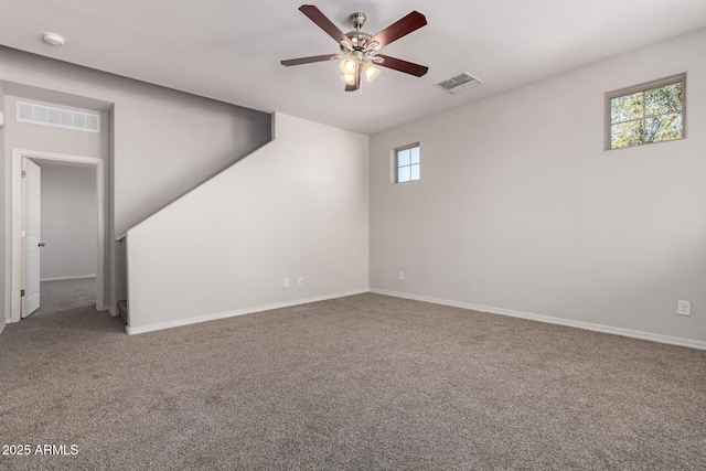 spare room with ceiling fan and carpet flooring