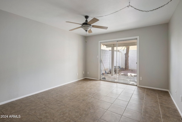 empty room featuring tile patterned floors and ceiling fan