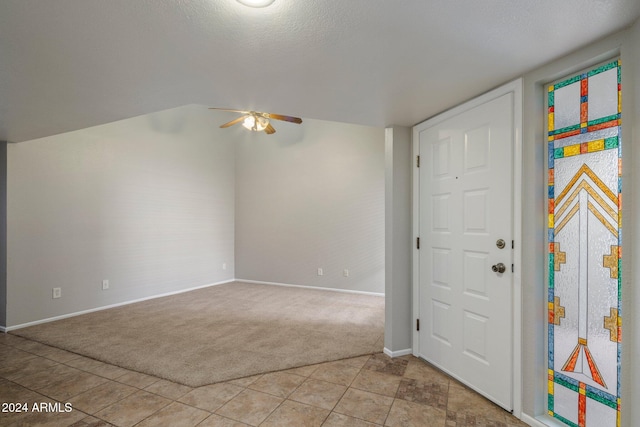 foyer featuring light carpet, a textured ceiling, ceiling fan, and lofted ceiling