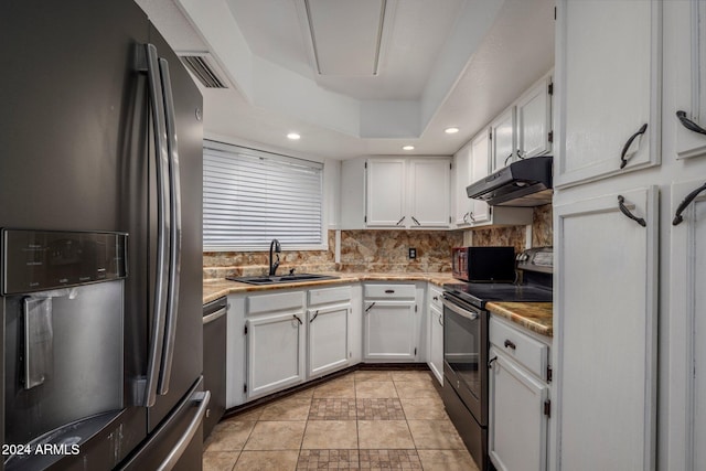 kitchen with black appliances, white cabinets, sink, and tasteful backsplash