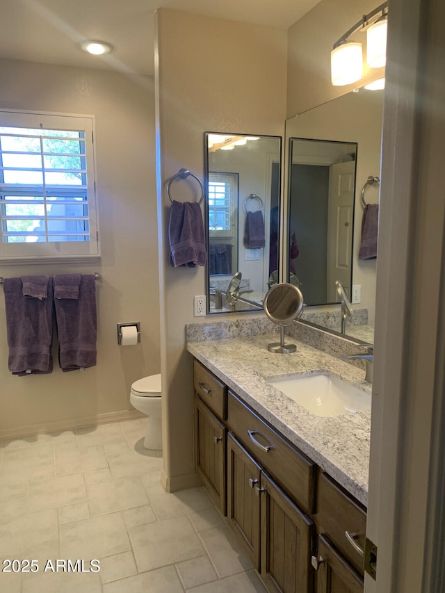 bathroom featuring vanity and toilet