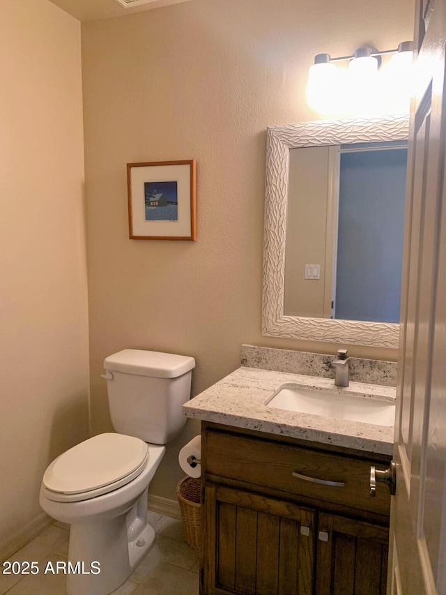 bathroom with vanity, tile patterned floors, and toilet