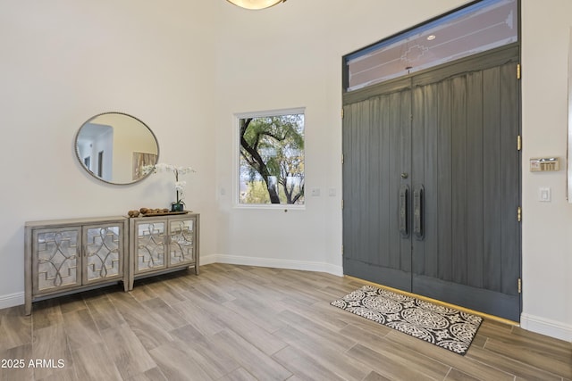 entryway featuring wood finished floors and baseboards