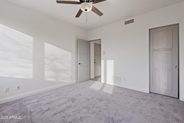 unfurnished bedroom with carpet, visible vents, and baseboards