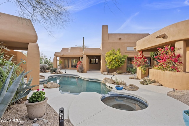 view of pool with a patio area and a pool with connected hot tub