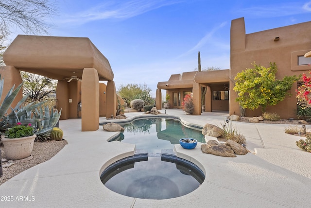 view of swimming pool with a pool with connected hot tub and a patio