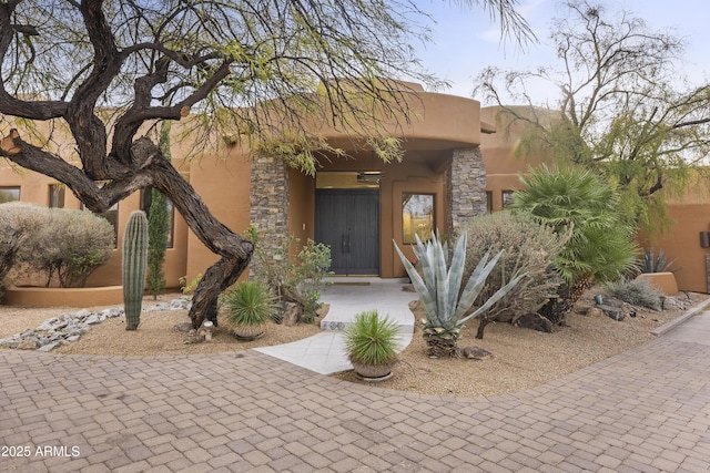 property entrance with stucco siding