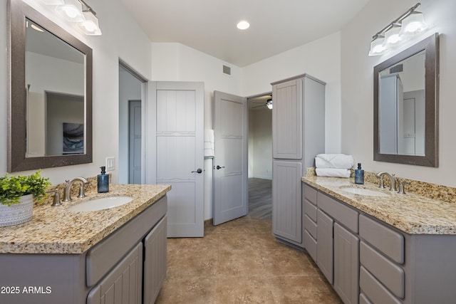 bathroom with two vanities, a sink, and visible vents