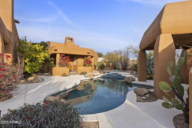 outdoor pool with a patio area