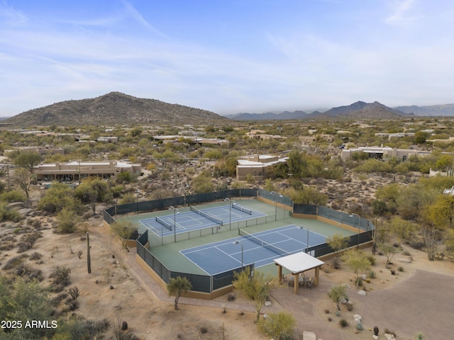 view of sport court with fence and a mountain view