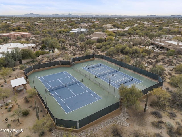 view of sport court featuring fence and a mountain view