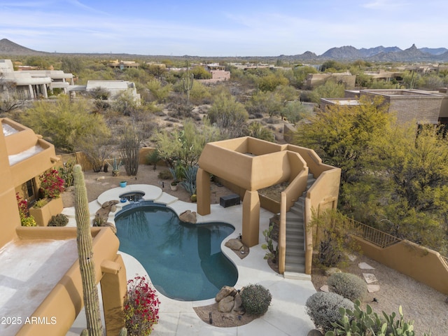 outdoor pool featuring a fenced backyard, a mountain view, and a patio