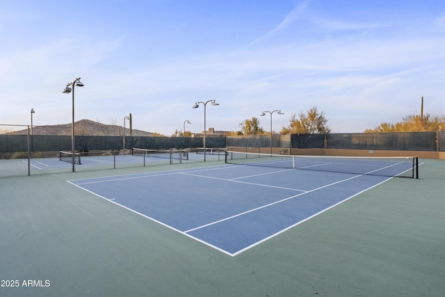 view of sport court featuring fence