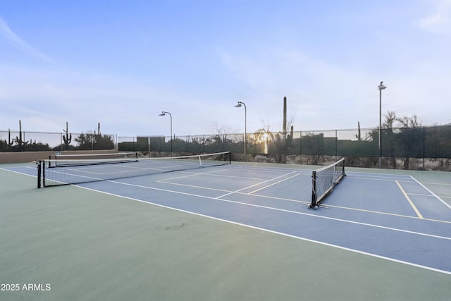 view of tennis court with fence