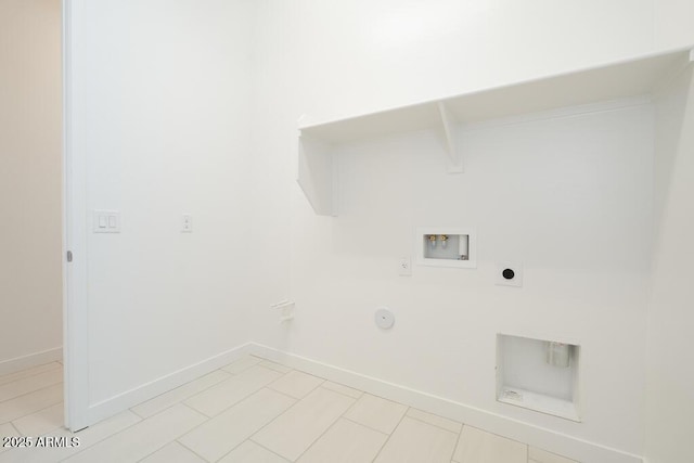 clothes washing area featuring electric dryer hookup, baseboards, gas dryer hookup, hookup for a washing machine, and laundry area