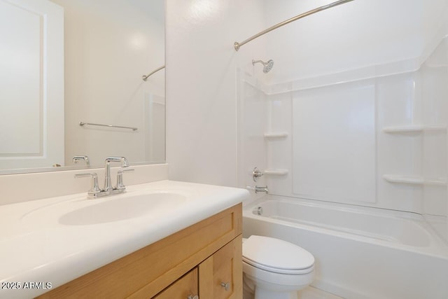 bathroom featuring vanity, shower / bathing tub combination, and toilet