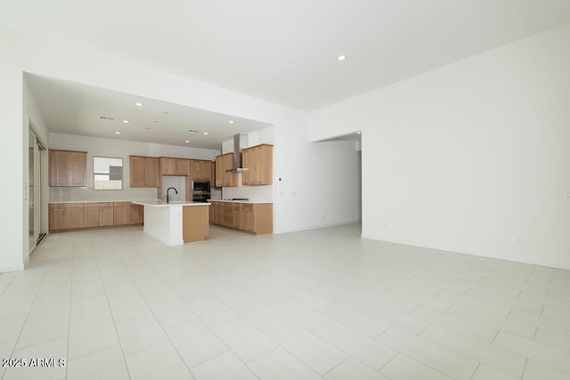 unfurnished living room featuring a sink and recessed lighting