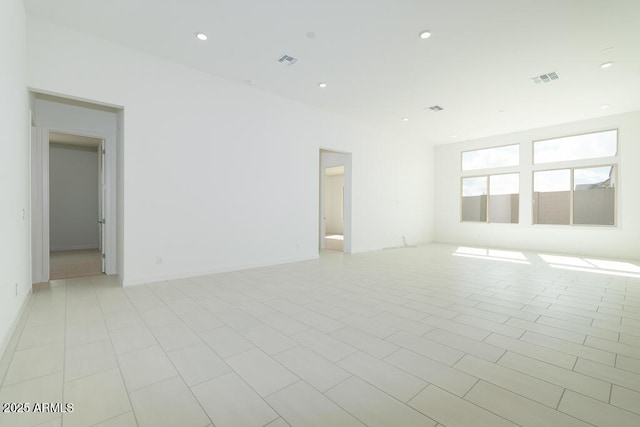 unfurnished room featuring recessed lighting, visible vents, and baseboards