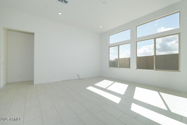 spare room featuring recessed lighting and visible vents