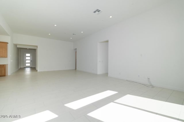 unfurnished room featuring visible vents, recessed lighting, and baseboards