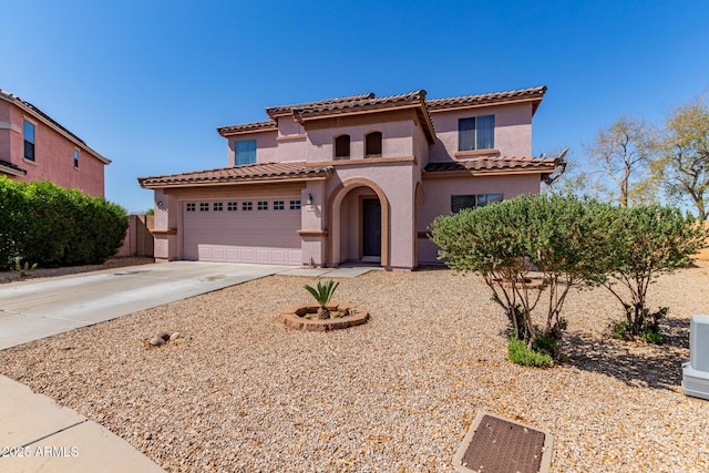 mediterranean / spanish-style house featuring a tile roof, driveway, and stucco siding