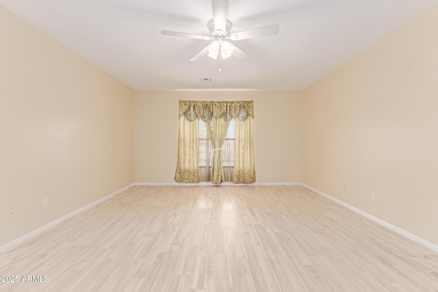 empty room with light wood-style flooring, baseboards, visible vents, and ceiling fan