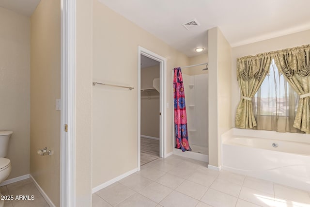bathroom with toilet, a shower stall, tile patterned flooring, and visible vents