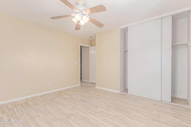 unfurnished bedroom with a closet, baseboards, a ceiling fan, and light wood-style floors