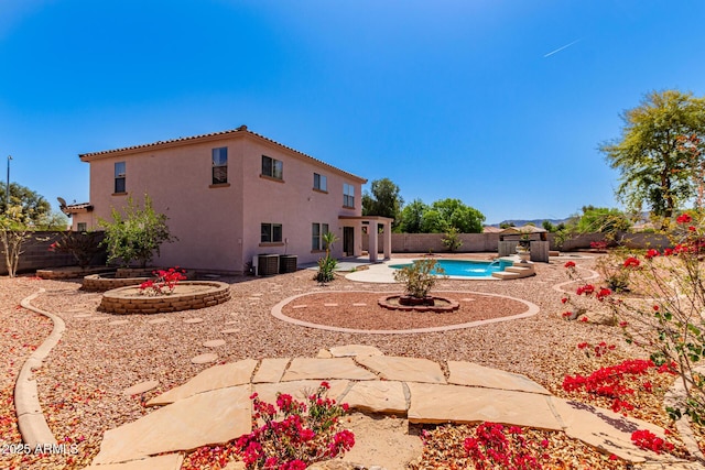 exterior space with a fenced backyard, stucco siding, a patio, a tile roof, and a fenced in pool