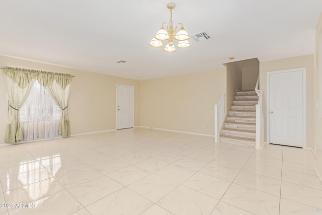 unfurnished room with visible vents, baseboards, stairway, and a chandelier
