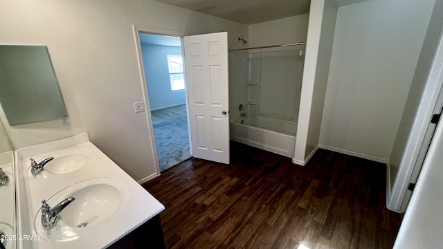 19841 W Cherry Lynn Rd W, Buckeye, AZ 85396 - bathroom featuring wood finished floors, double vanity, and bathtub / shower combination