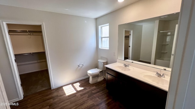 19841 W Cherry Lynn Rd W, Buckeye, AZ 85396 - full bathroom featuring wood finished floors, a shower, a walk in closet, double vanity, and a tub