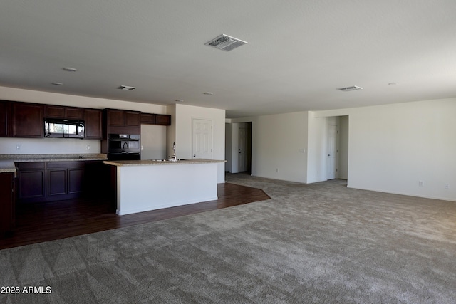 19841 W Cherry Lynn Rd W, Buckeye, AZ 85396 - kitchen with black appliances, dark carpet, open floor plan, and dark brown cabinetry