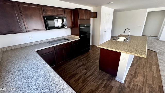 19841 W Cherry Lynn Rd W, Buckeye, AZ 85396 - kitchen with black appliances, dark wood-style flooring, a center island with sink, and dark brown cabinets